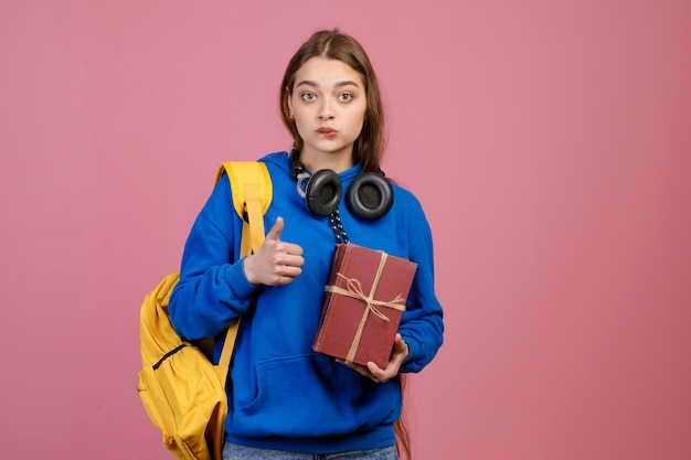 Young student standing holding present