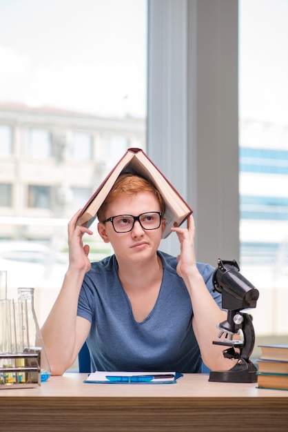 Photo young student tired and exhausted preparing for chemistry exam