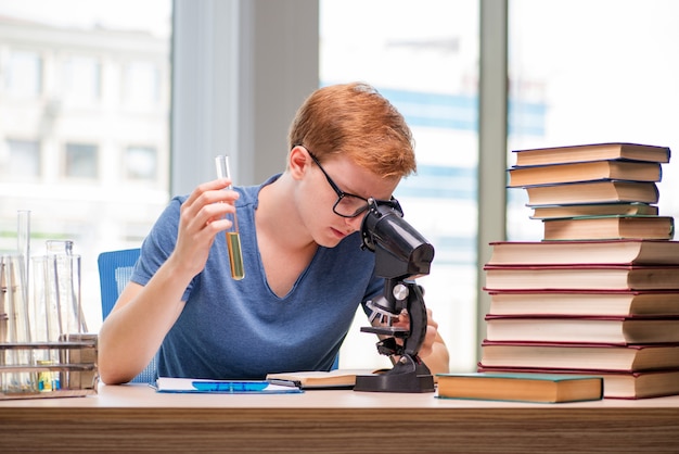 Photo young student tired and exhausted preparing for chemistry exam