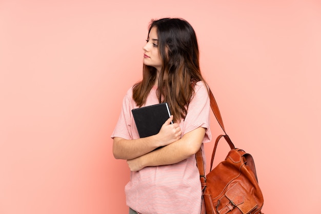 Young student woman over isolated wall