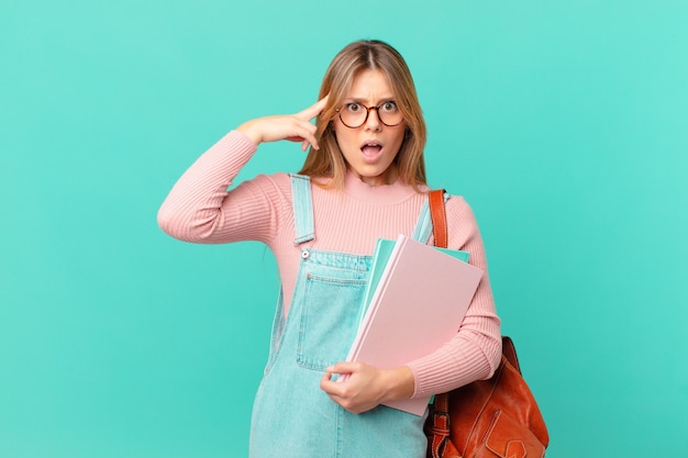 Young student woman looking surprised, realizing a new thought, idea or concept