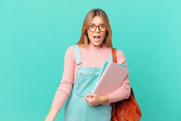 Young student woman looking very shocked or surprised