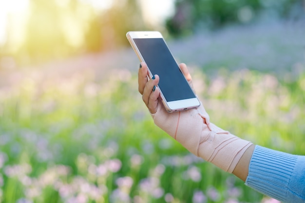 Young student women shopping online on smartphone while wrist hand pain