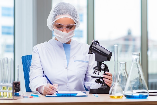 Young student working with chemical solutions in lab