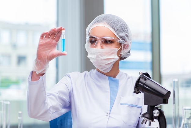 Young student working with chemical solutions in lab