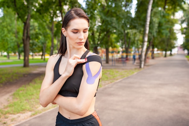 Young stunning muscular woman wearing black sports outfit