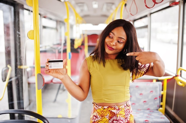 Young stylish african american woman riding on a bus