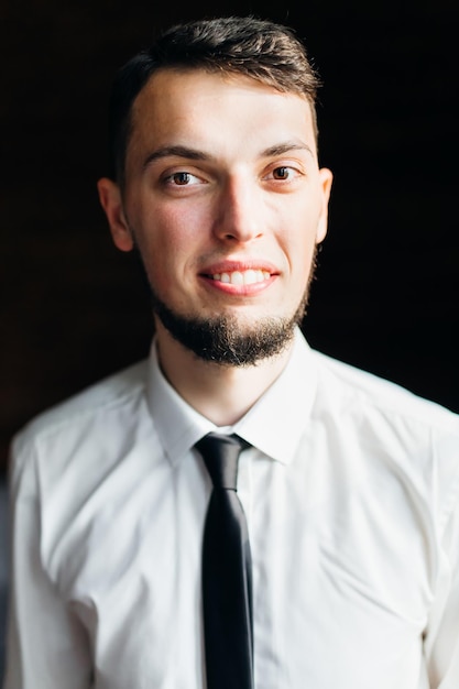 Young and stylish groom with a beard is smiling Morning preparation of the wedding ceremony