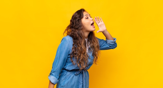 young stylish pretty woman on yellow background