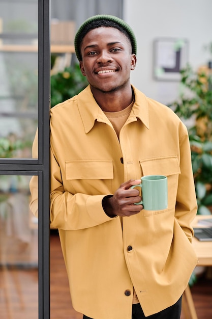 Young successful african american businessman with cup of coffee