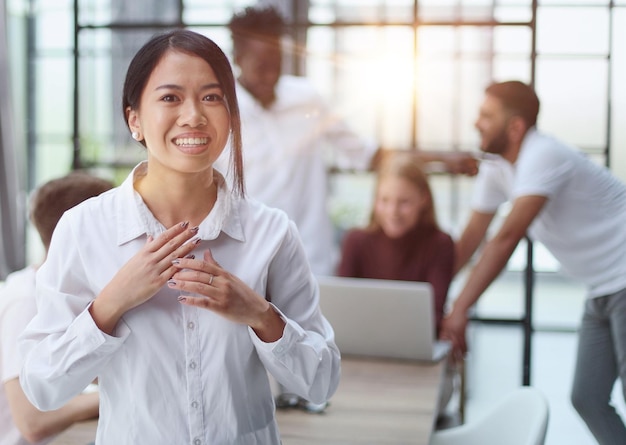 young successful businesswoman in white shirt smiling in the office