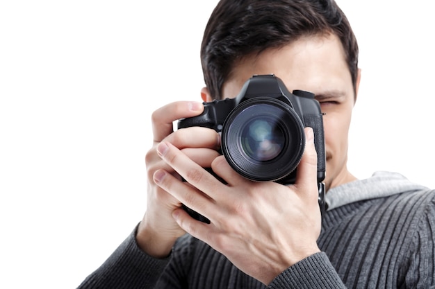 Young successful professional photographer in shirt use DSLR digital camera isolated on white background. closeup