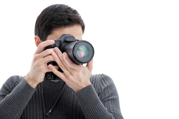 Young successful professional photographer in shirt use DSLR digital camera isolated on white background