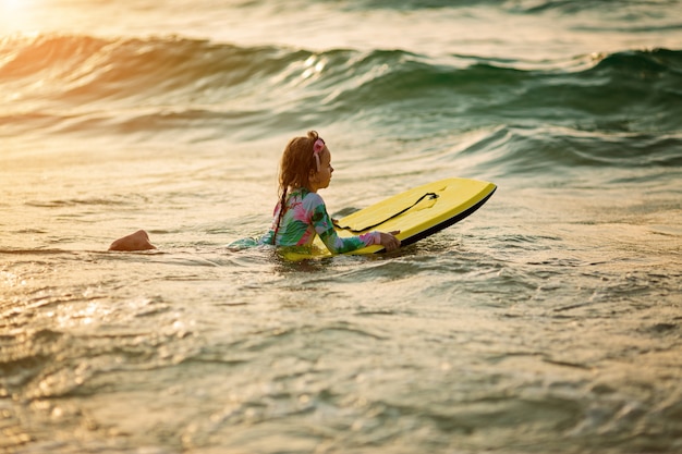 young surfer ride on surfboard with fun on sea waves