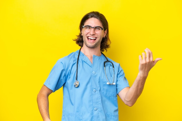 Young surgeon caucasian man isolated on yellow background making guitar gesture