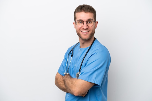 Young surgeon doctor caucasian man isolated on white background with arms crossed and looking forward