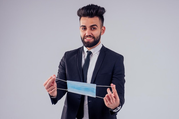 Young syrian handsome black hair man in stylish business suit in studio isolate white background