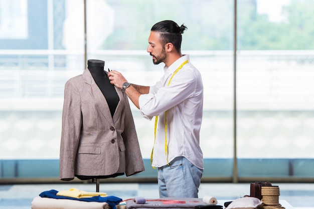 Young tailor working on new clothing design