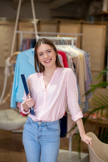 A young and talented designer of women's clothing, conducting a presentation of her new clothing collection