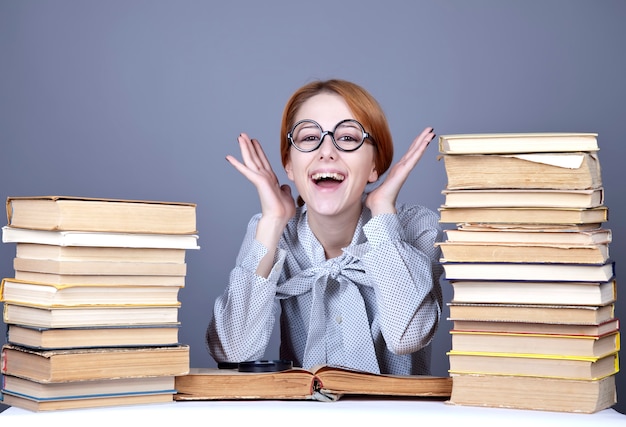 The young teacher in glasses with books. 