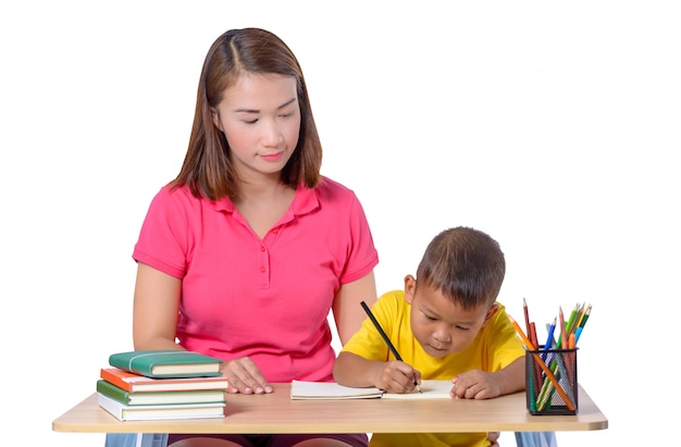 Young Teacher helping child with writing lesson isolated on white background