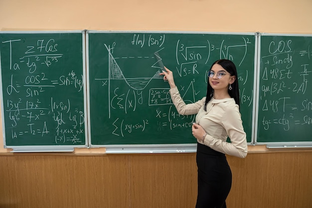 young teacher or student standing near blackboard and learn math lesson. education concept