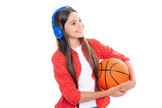 Young teenage child girl basketball player standing on white background