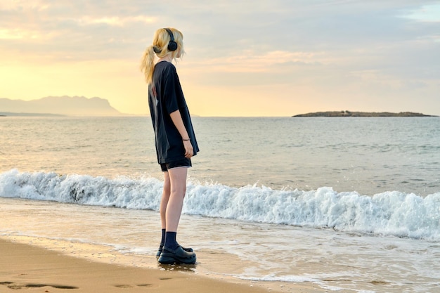 Young teenage female on the beach in the morning