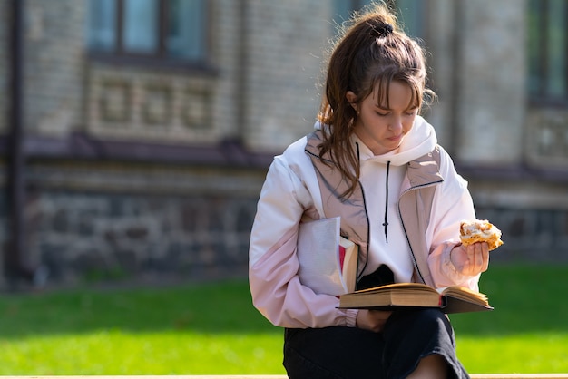 Young teenage girl snacking on a sandwich