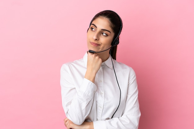 Young telemarketer over isolated background and looking up