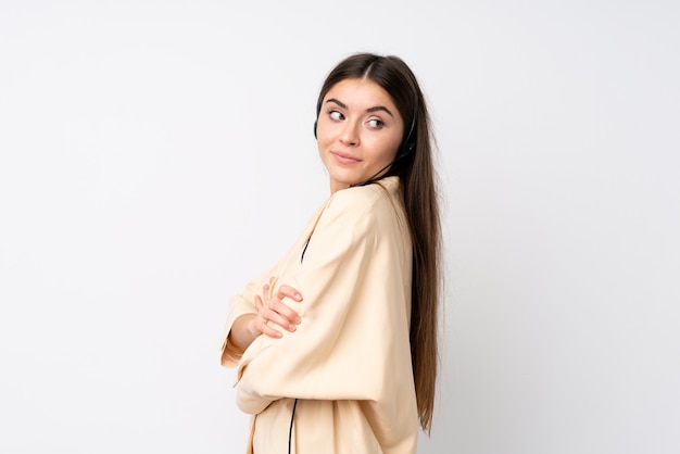 Young telemarketer woman over isolated  laughing