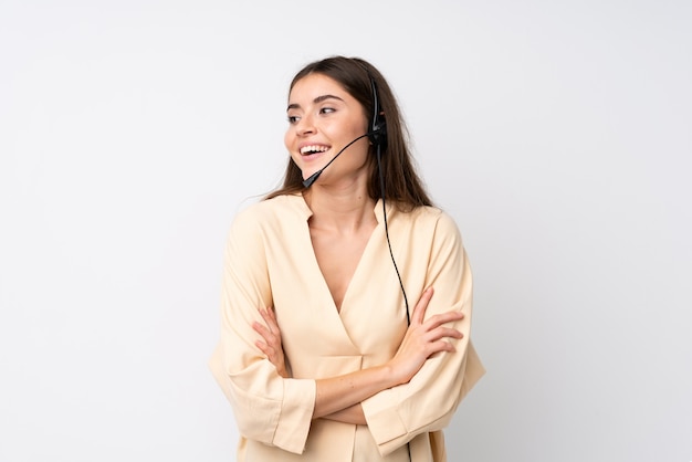 Young telemarketer woman over isolated white laughing