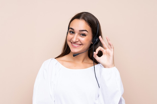 Young telemarketer woman showing ok sign with fingers