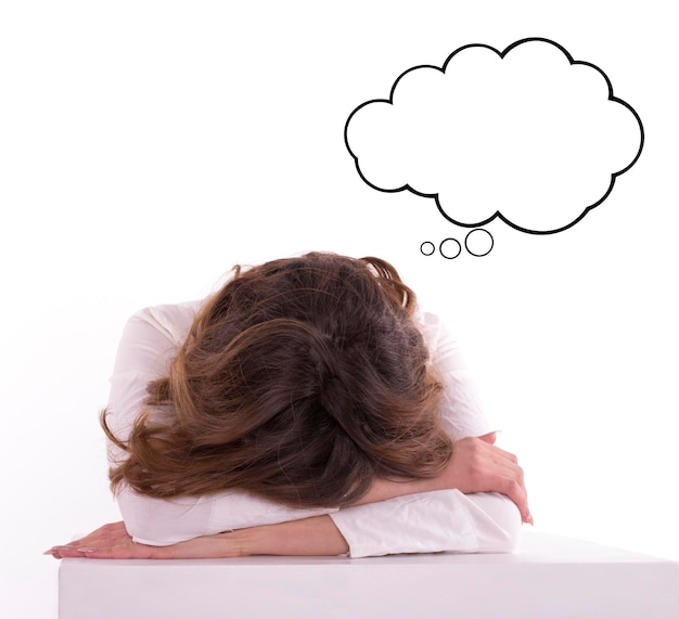 Young tired woman student sleeping on the table