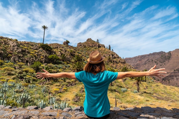 A young tourist enjoying the views at the viewpoint of El Palmarejo in La Gomera Canary Islands