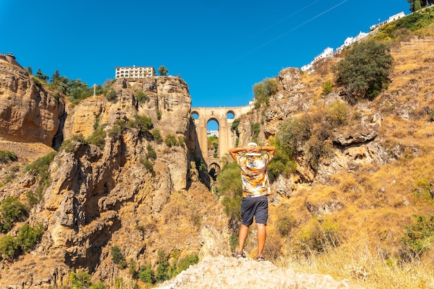 A young tourist visiting the new bridge viewpoint in Ronda province of Malaga Andalucia