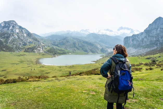 A young tourist with a backpack at the Entrelagos viewpoint of Lake Ercina in the Lakes of Covadonga Asturias Spain