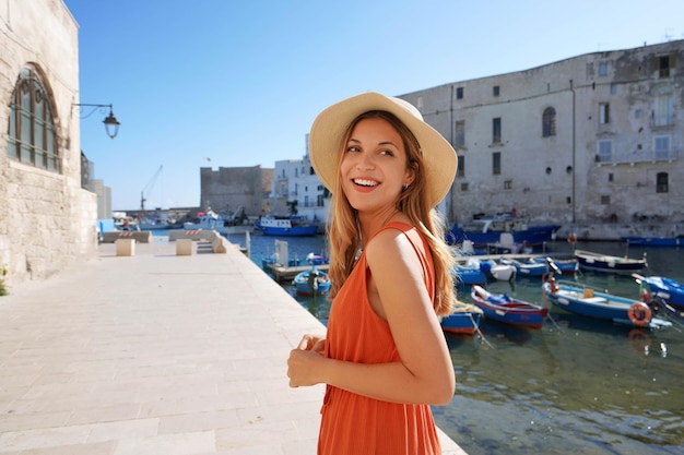 Young tourist woman in the ancient town and port of Monopoli Apulia Italy