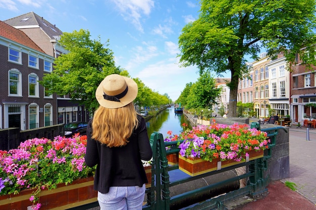 Young tourist woman between flower pots in The Hague Netherlands