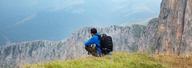 Young traveler hiking man with backpacks