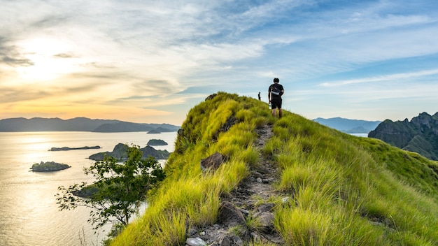 A Young Traveler Walking on The Route to The Top of Padar Island at Sunset. Komodo Nationa