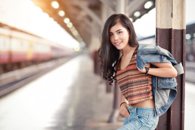 Young traveler woman with jacket jean waiting for train