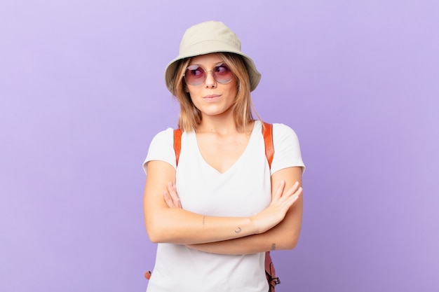 Young traveller tourist woman shrugging feeling confused and uncertain