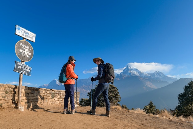 A young traveller trekking in Poon Hill view point in Ghorepani Nepal