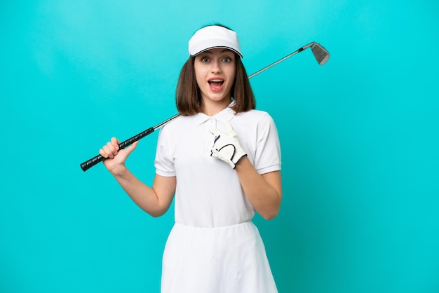 Young Ukrainian golfer player woman isolated on blue background with surprise facial expression