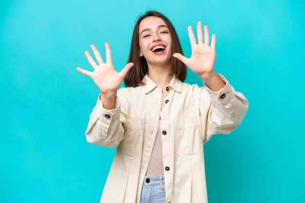 Young Ukrainian woman isolated on blue background counting ten with fingers