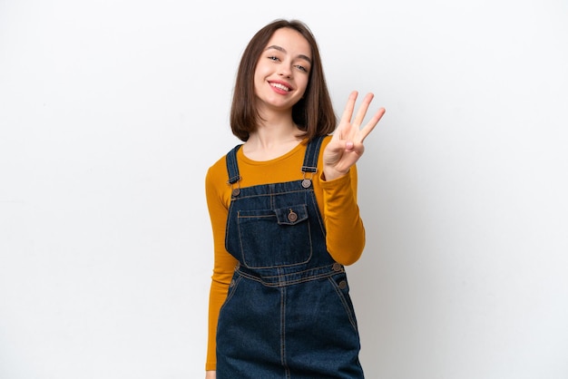 Young Ukrainian woman isolated on white background happy and counting three with fingers