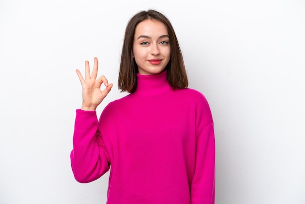 Young Ukrainian woman isolated on white background showing ok sign with fingers