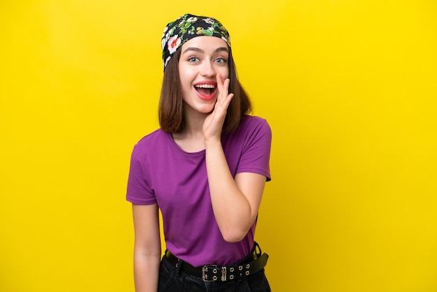 Young Ukrainian woman isolated on yellow background with surprise and shocked facial expression