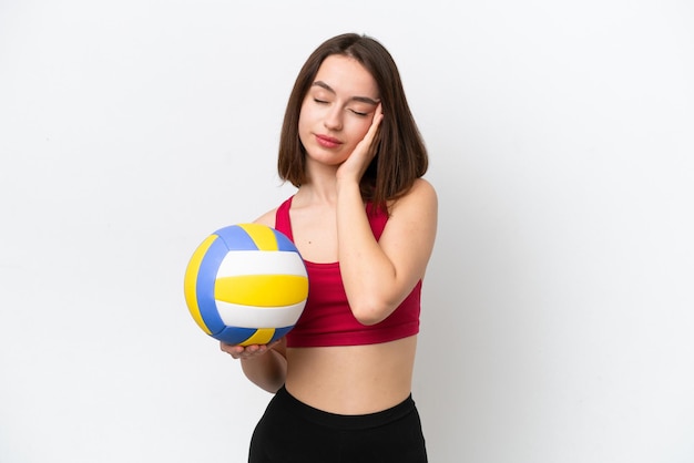 Young Ukrainian woman playing volleyball isolated on white background with headache